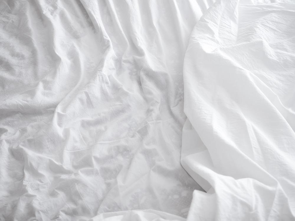 White, crumpled bed sheets.