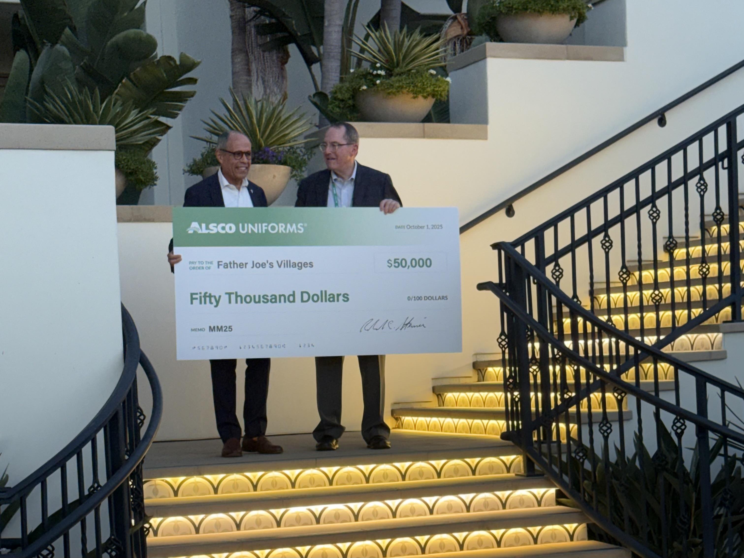 Alsco Uniforms CEO Bob Steiner delivering a $50,000 donation check to Father Joe's Villages CEO Jim Vargas