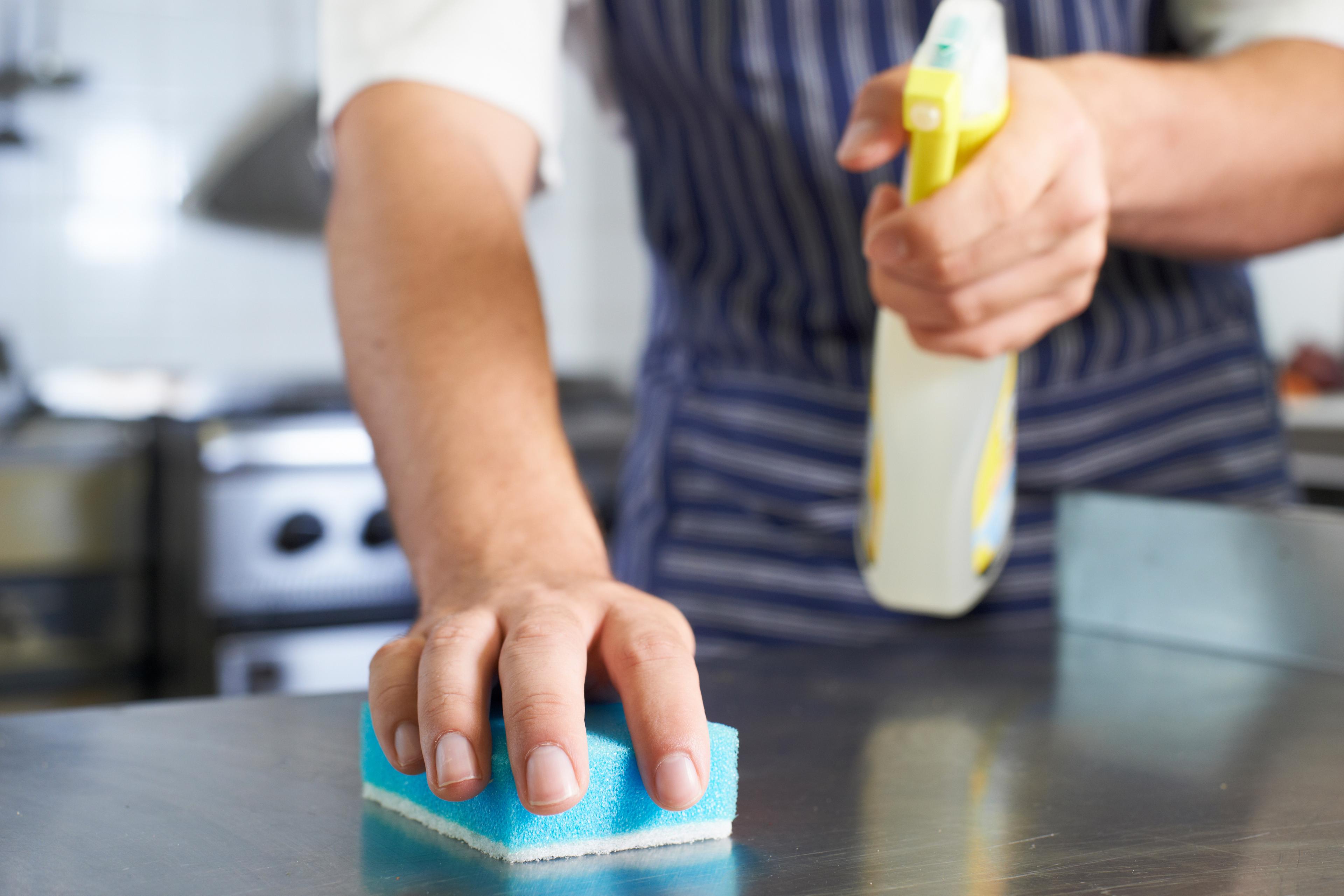 Restaurant worker cleaning a countertop
