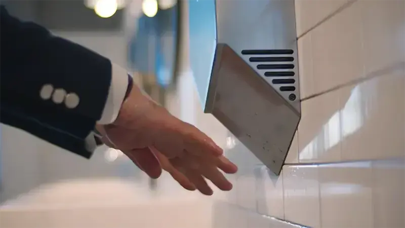 Electric hand dryer in use
