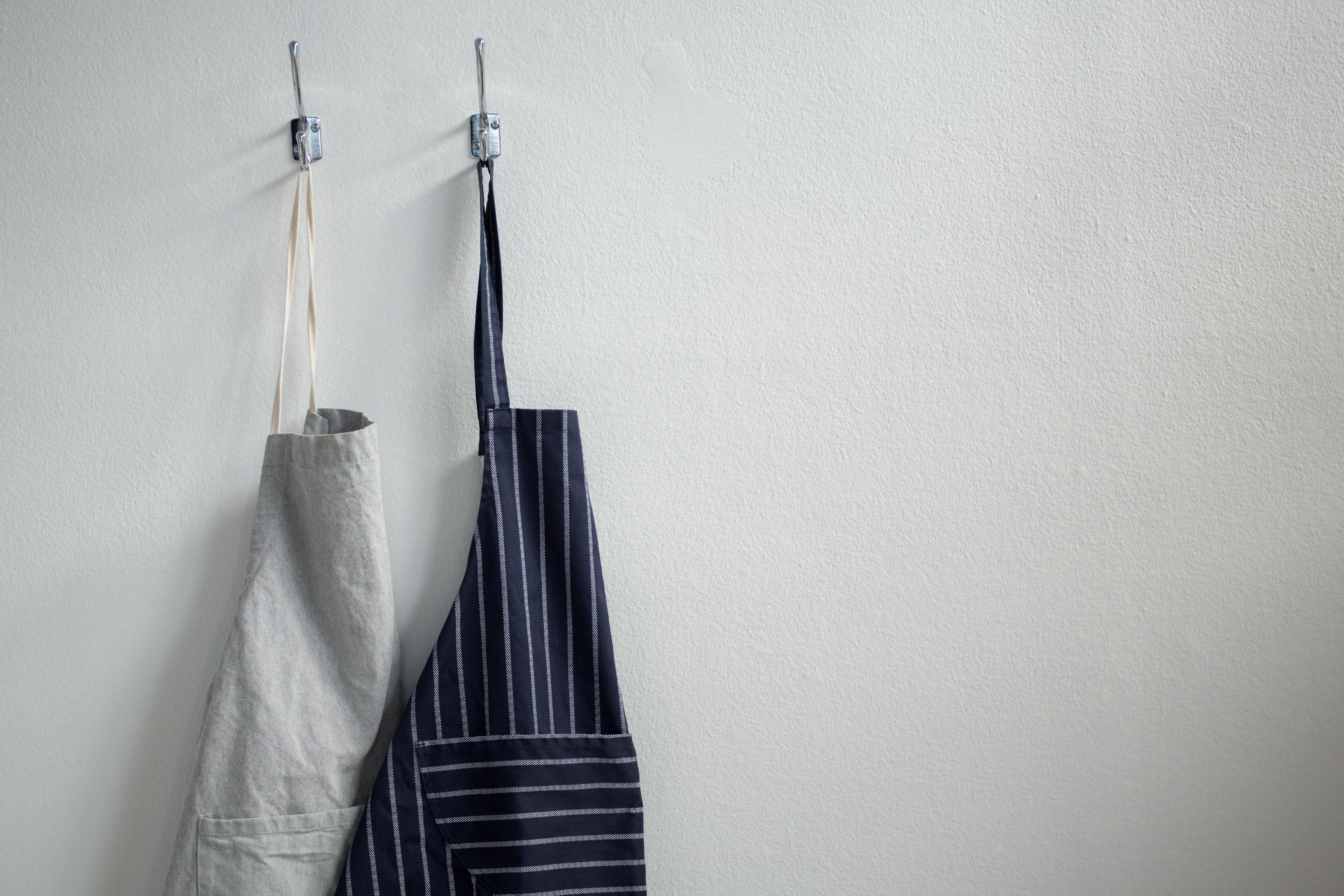 Aprons hanging on hooks