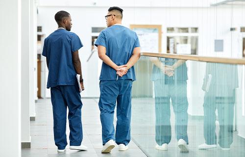 Healthcare professionals in scrubs walking