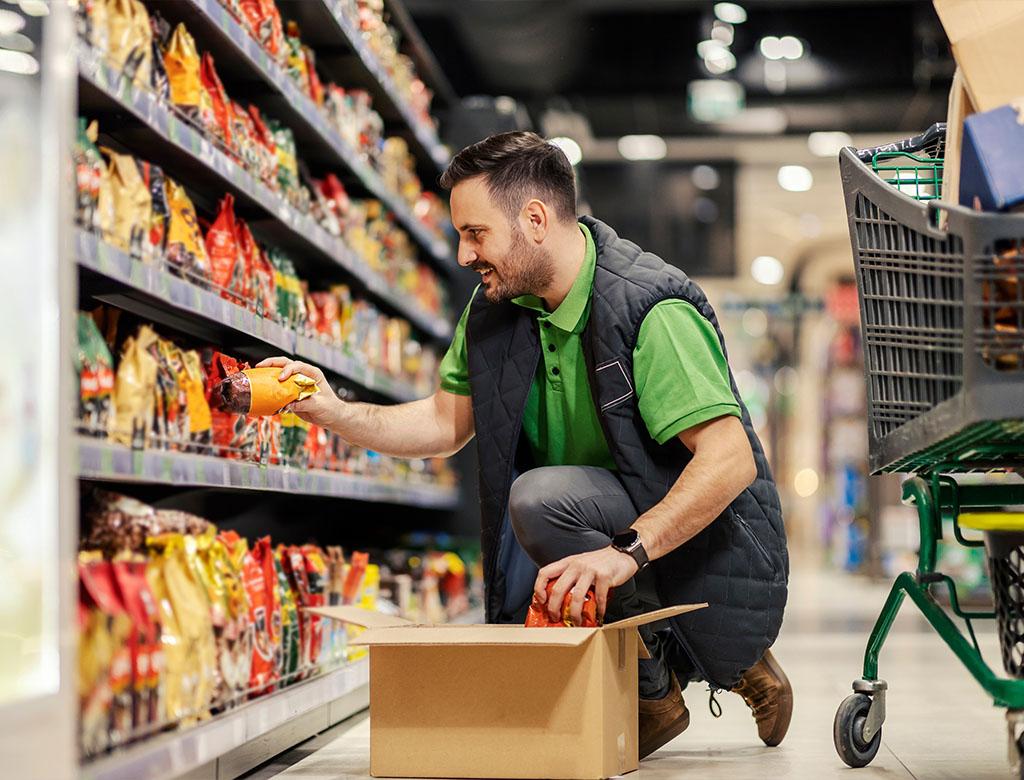 Restocker filling shelves in retail store