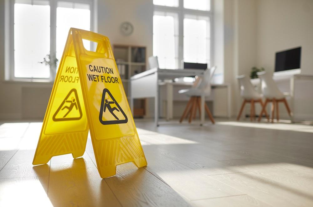 A "Caution Wet Floor" sign in an office.