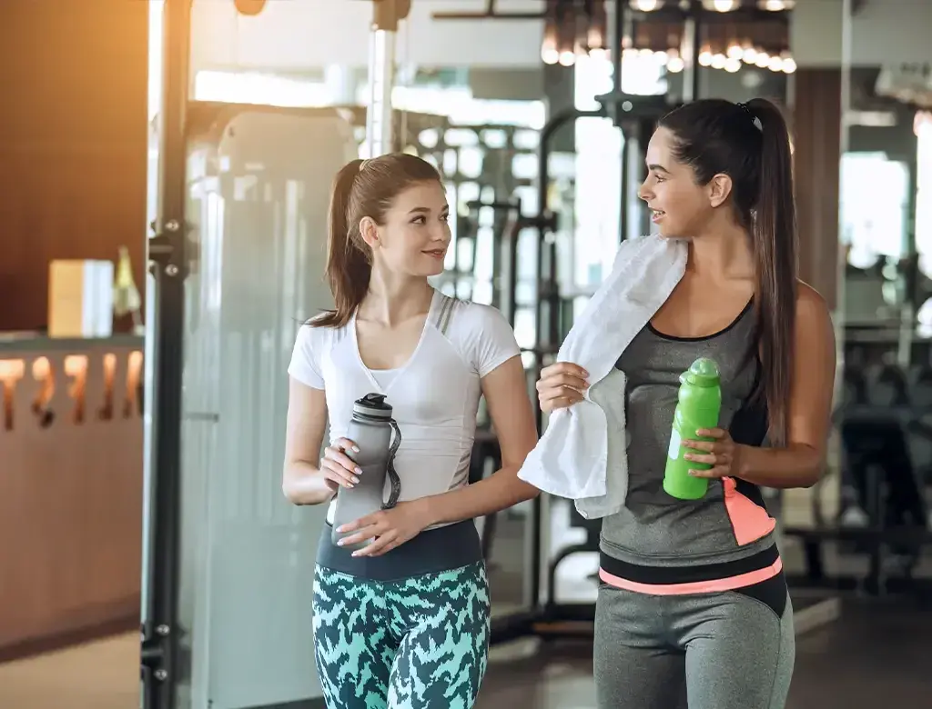 Gym goers finishing a workout with a gym towel